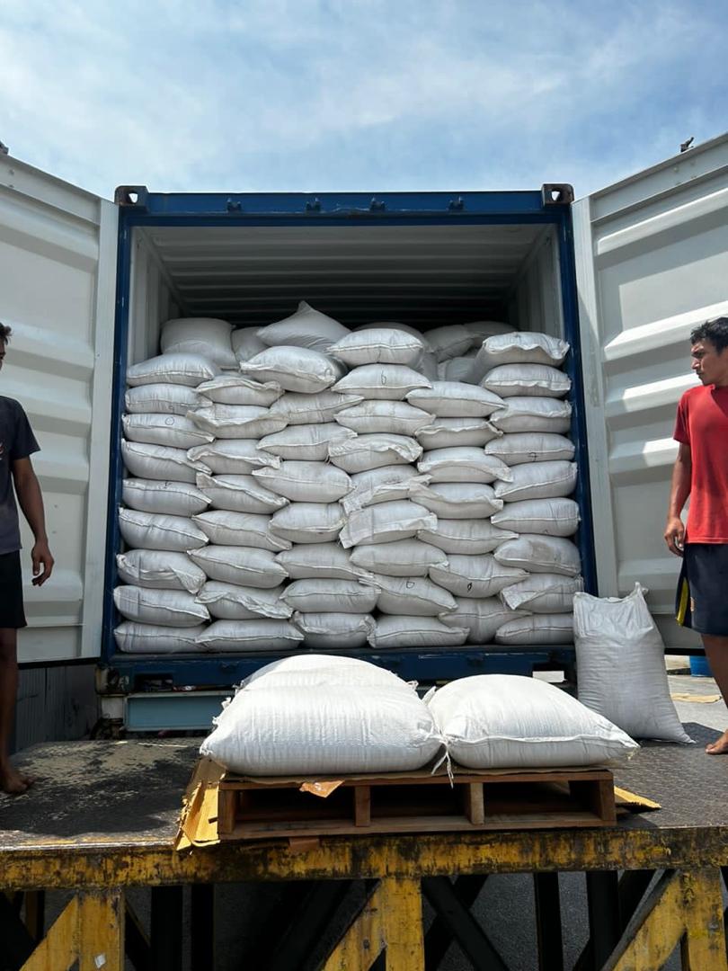 Shipping Container With Workers And Sacks