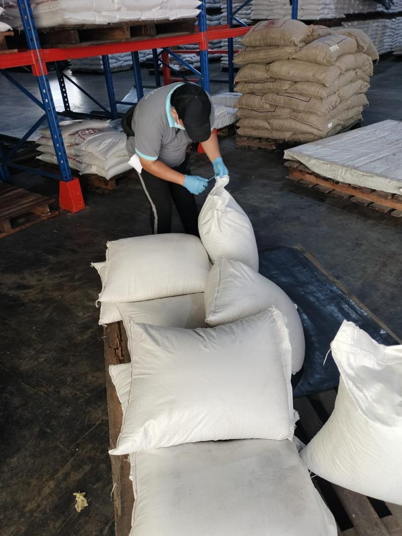 Warehouse Worker Tying Sack